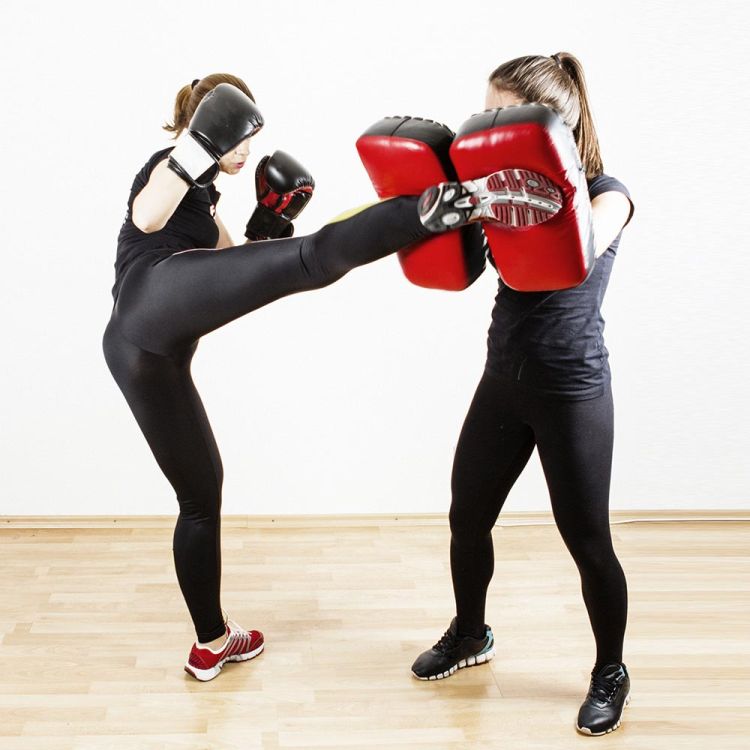 Woman Kicking Shield in Private Self Defence Lesson